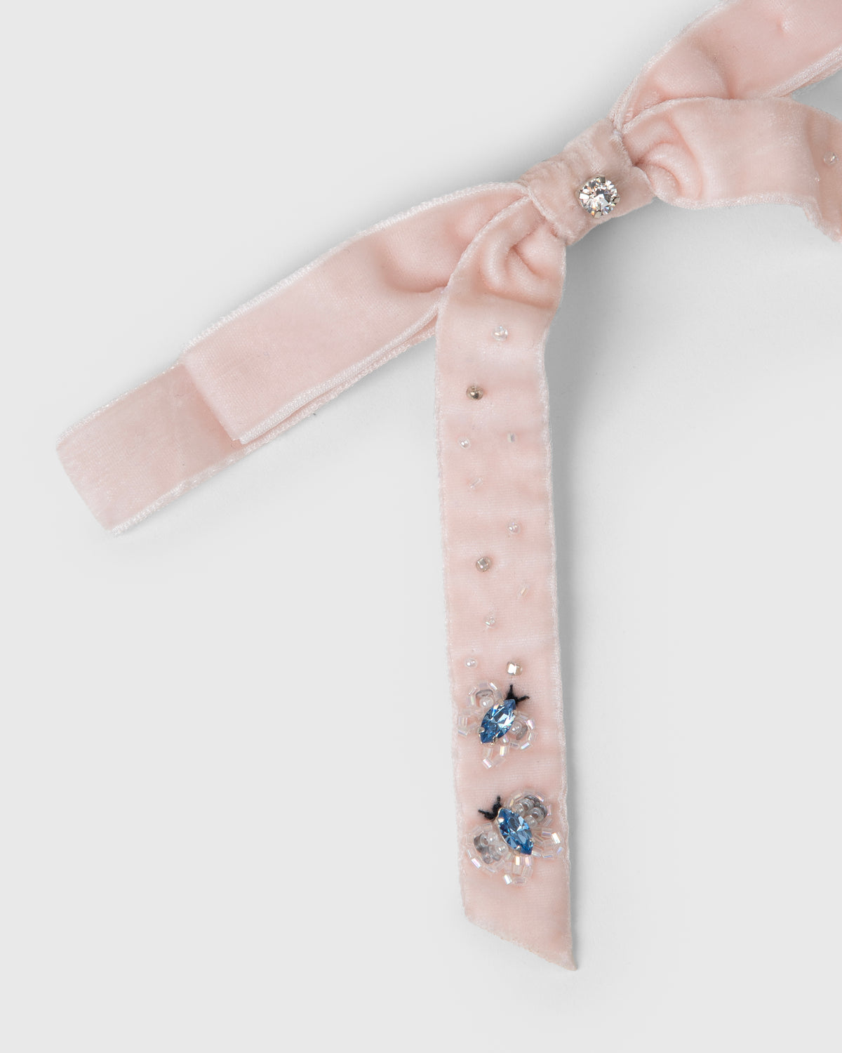 Close-up of Pink Velvet Butterfly Crystal Bow Clip with crystal embellishments by House of Carousél