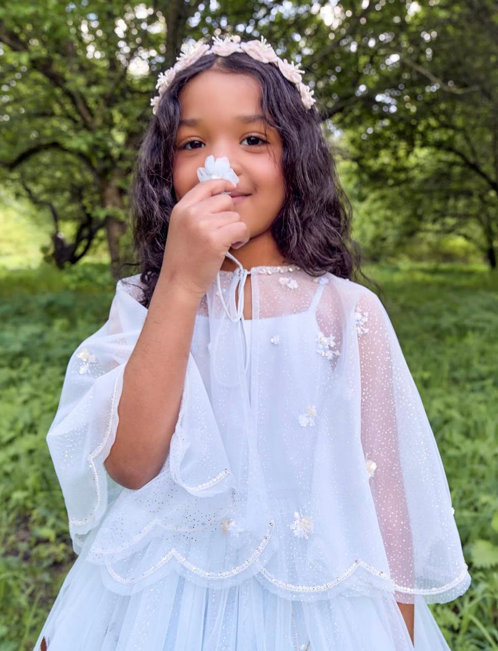 Girl wearing Blossom Headband by House of Carousel with delicate pink flowers