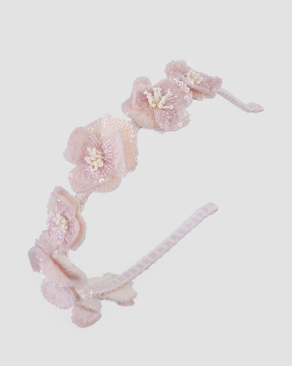 Blossom organza flower headband with layered pink petals and pearl details by House of Carousel