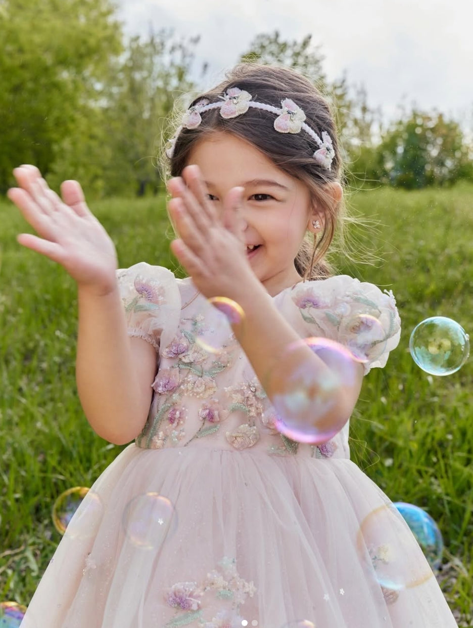 Girl wearing Butterfly Ballet Headband with pink and lilac butterfly embellishments by House of Carousel