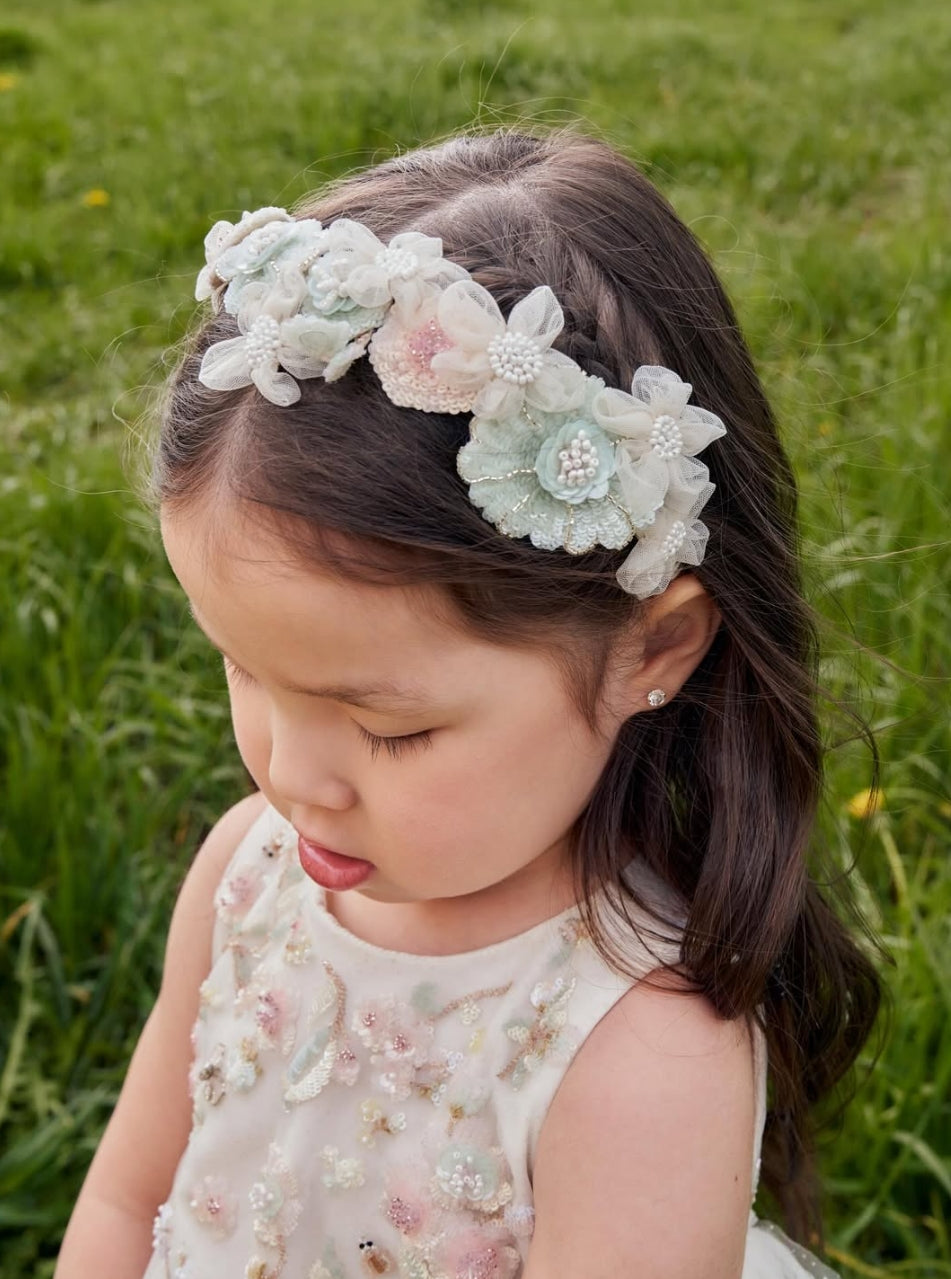 Girl wearing Crown of Grace handcrafted floral headband by House of Carousel