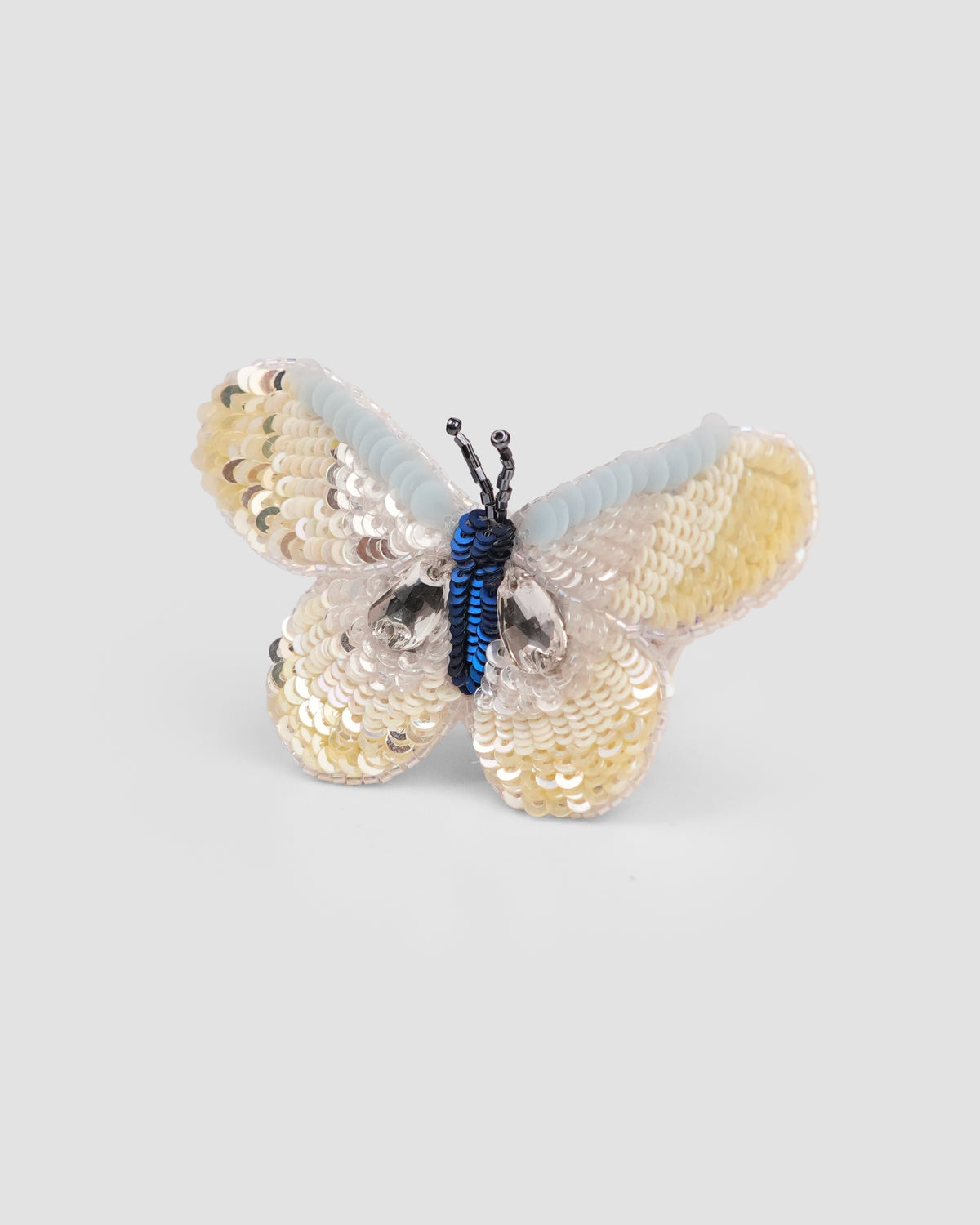 The Daydream butterfly hair clip with lemon, pale blue and silver sequin wings by House of Carousél