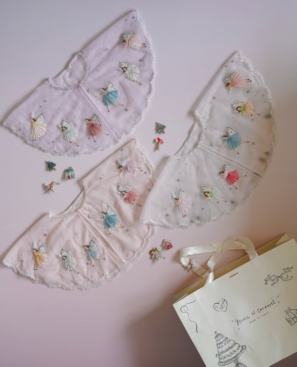 Sheer cape detail with handcrafted fairies, silver stars and embroidered wings by House of Carousel