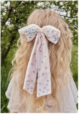 Girl wearing the Fleur de Velvet Bow by House of Carousel