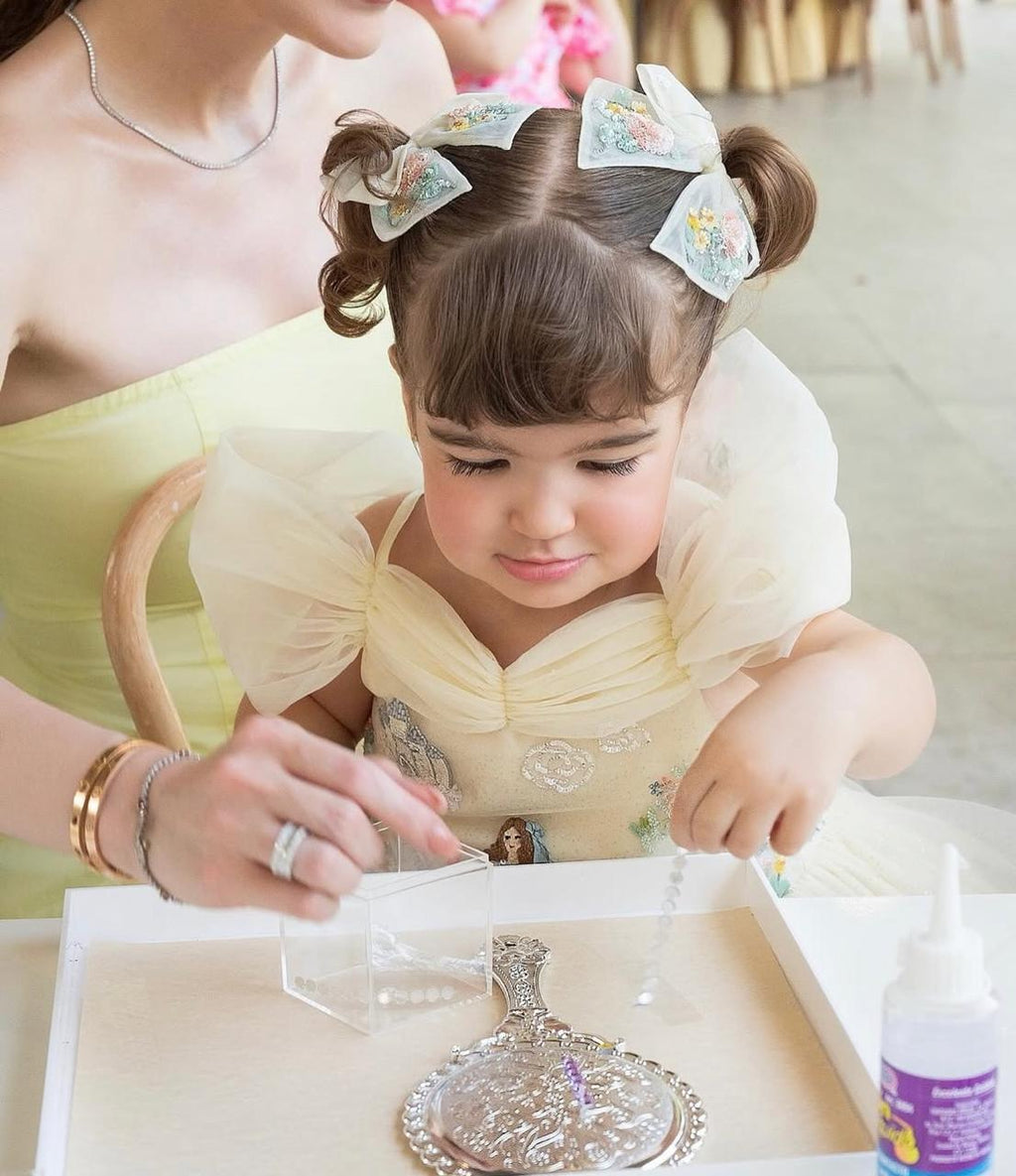 Girl wearing the Floral Tulle Bow Clip by House of Carousel
