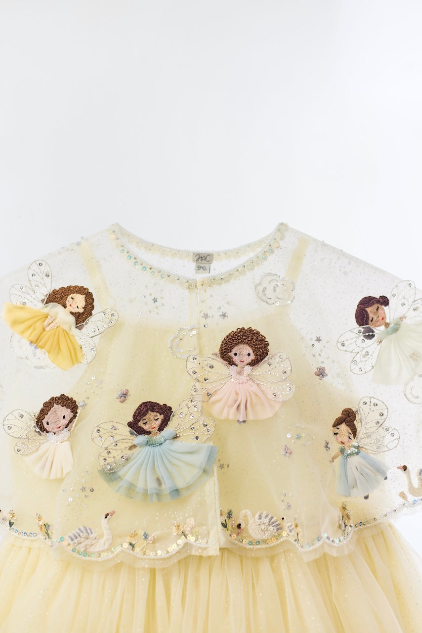 Close-up of embroidered fairies, clouds and beadwork on the Flutter Fairy Cloudkiss Dress by House of Carousel