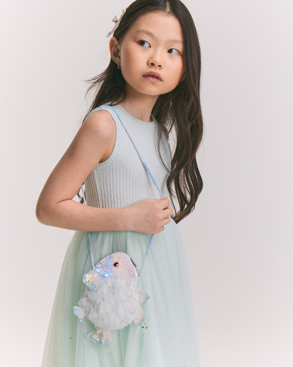 Girl  wearing the Moon Fish Ruffle Bag by House of Carousél