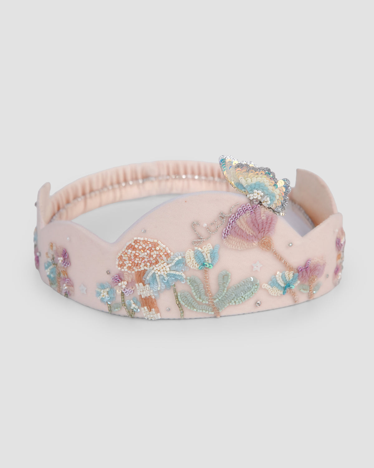 Hand-embroidered bunny, flower and butterfly details on the Hop in the Wild Crown