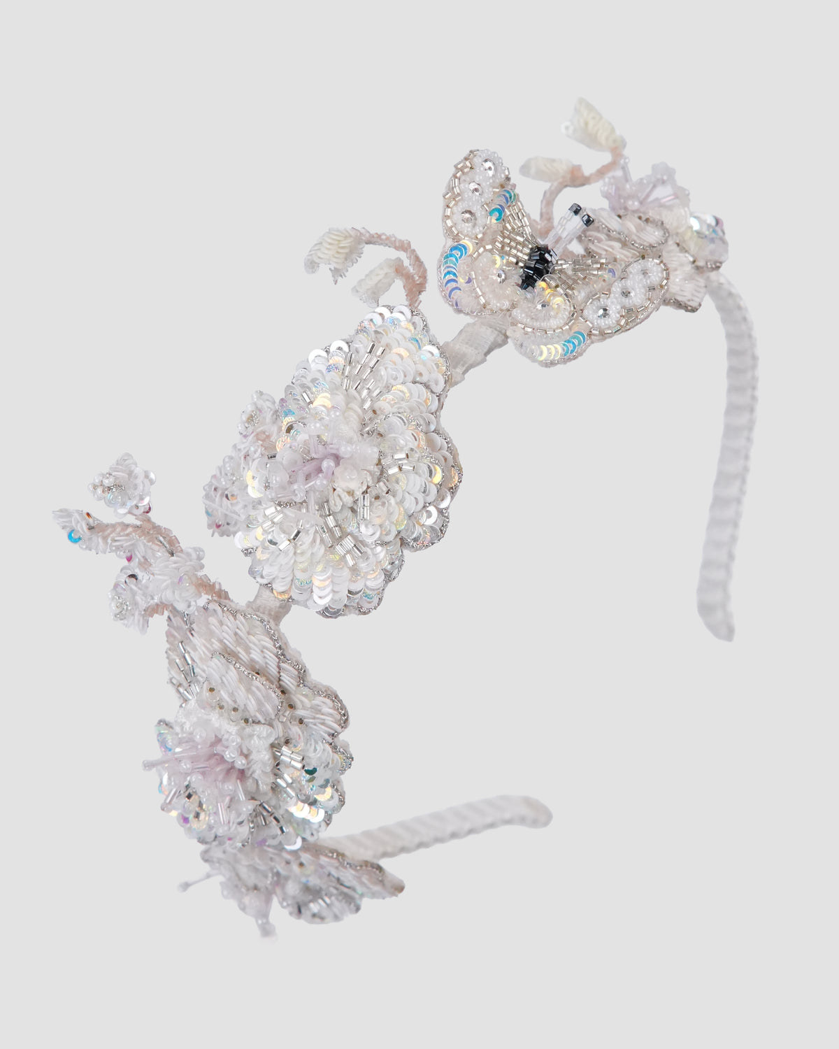 Girls ivory flower headband with dimensional blooms and delicate sequin embellishments by House of Carousél