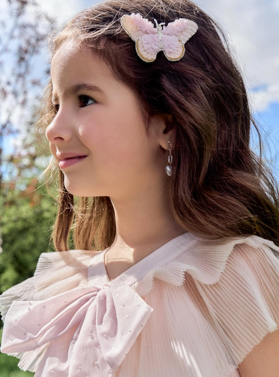 Girl wearing the Tulle Flutter butterfly hair clip by House of Carousél