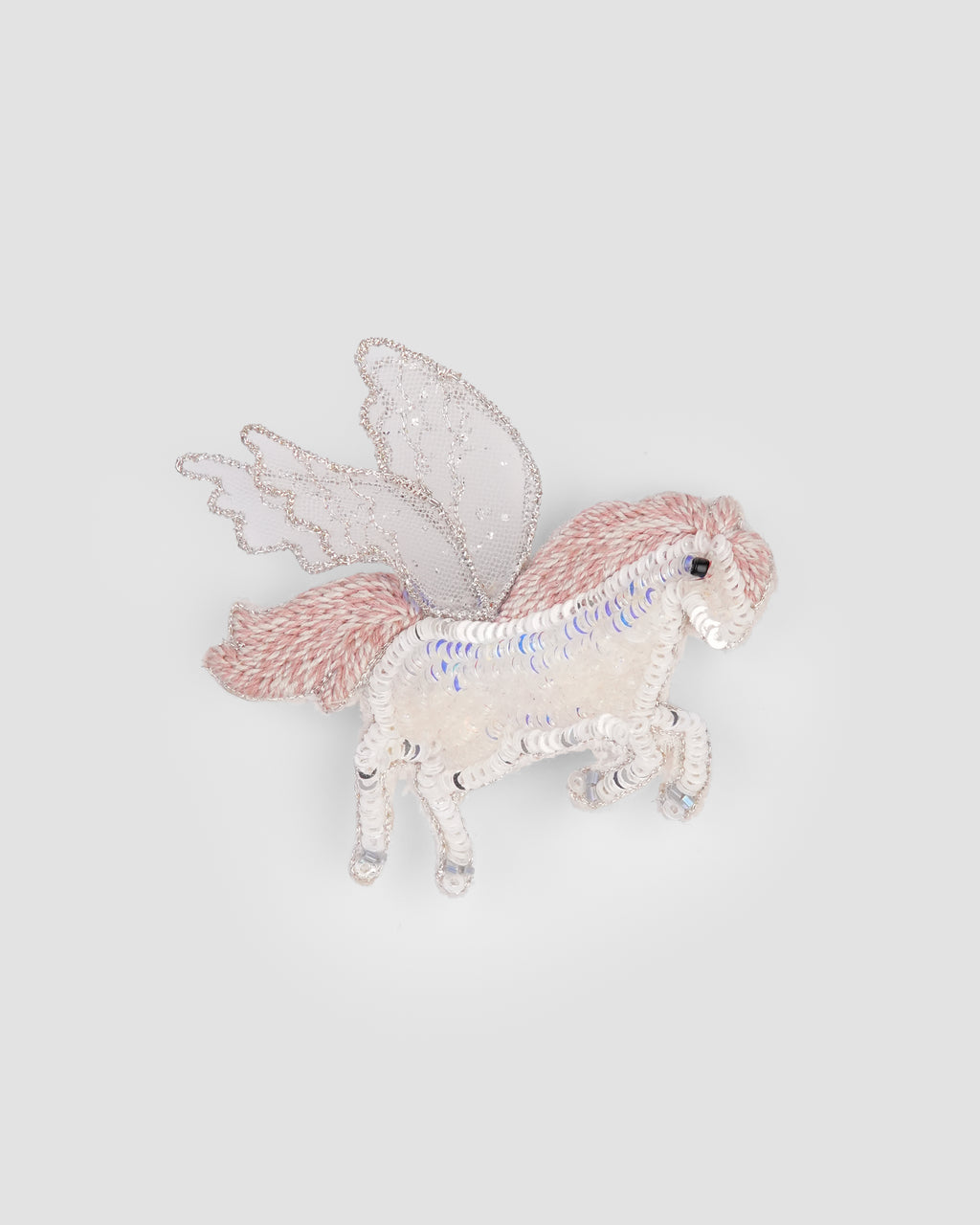 Hand embroidered unicorn hair clip with pink mane and iridescent sequin details by House of Carousél