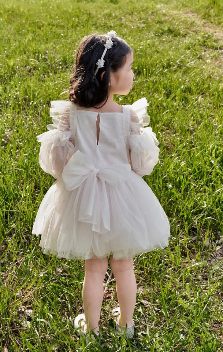 Girl wearing Unicorn Meadow Dress, a luxury embroidered occasion dress by House of Carousél