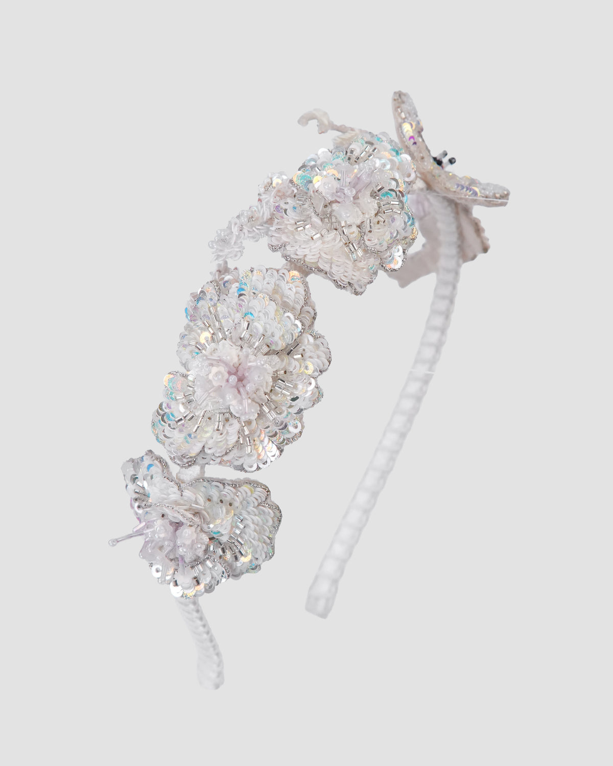 Whispers of Spring Headband by House of Carousél with ivory flowers and butterfly detail available at House of Aura Lebanon